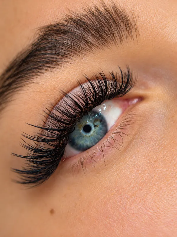 Classic eyelash extensions on blue eyes