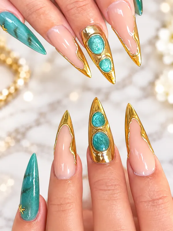 Gold chrome stiletto nails with turquoise stones