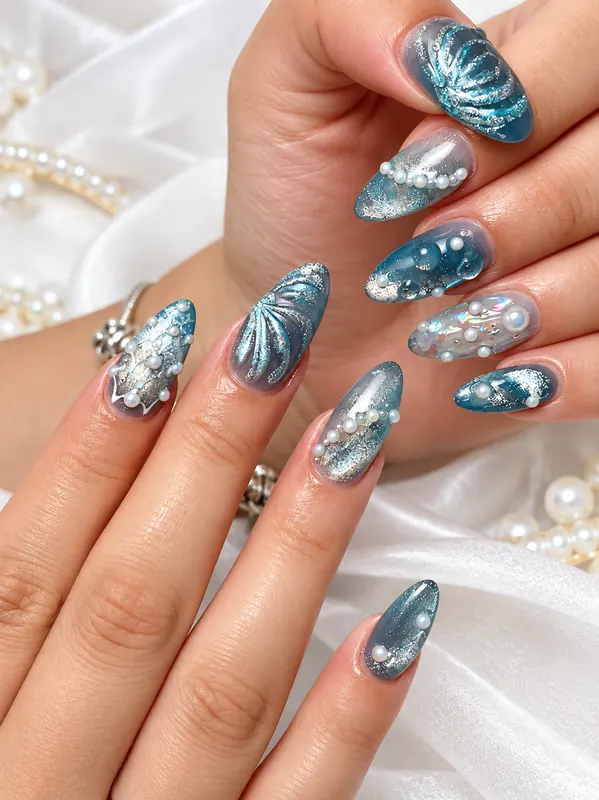 Blue cat eye nails with pearls and shell design