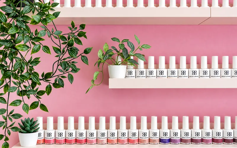 Pink wall with gel polish colours in the salon