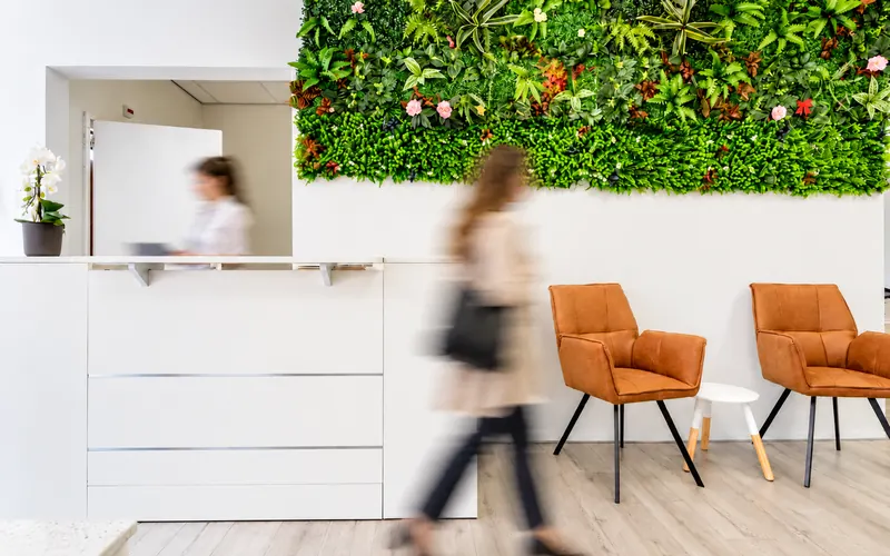 Reception with green plant wall at AnniLash Nail & Brow